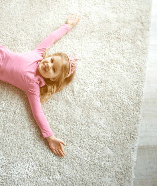 Cute girl laying on rug | Bob & Pete's Floors